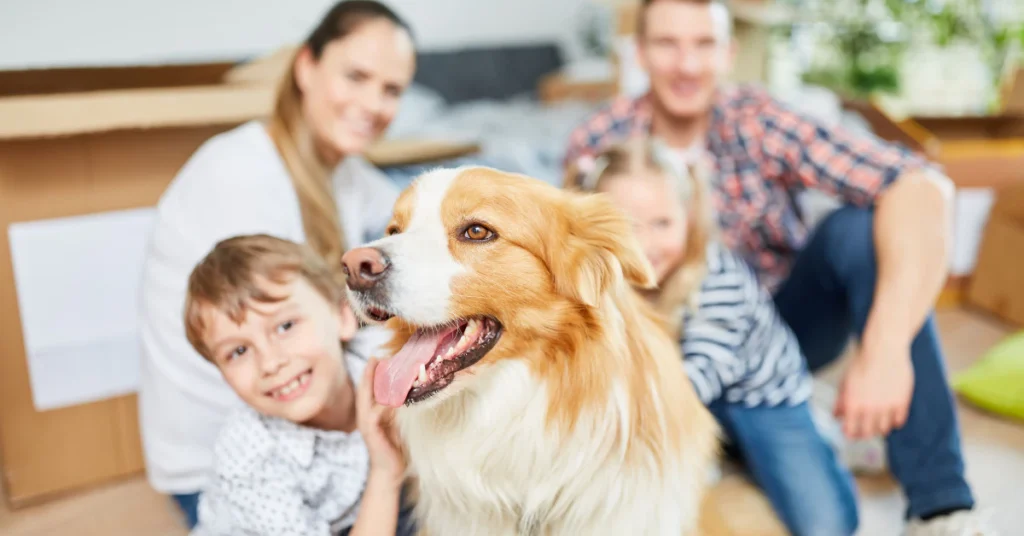Happy family with a golden retriever dog at home