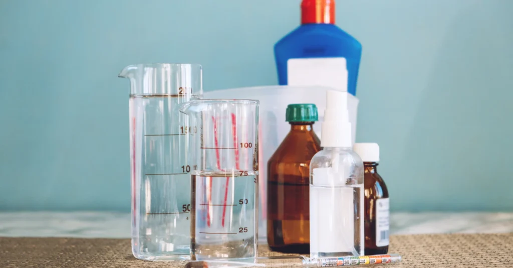 Glass bottles and containers of liquid on a shelf